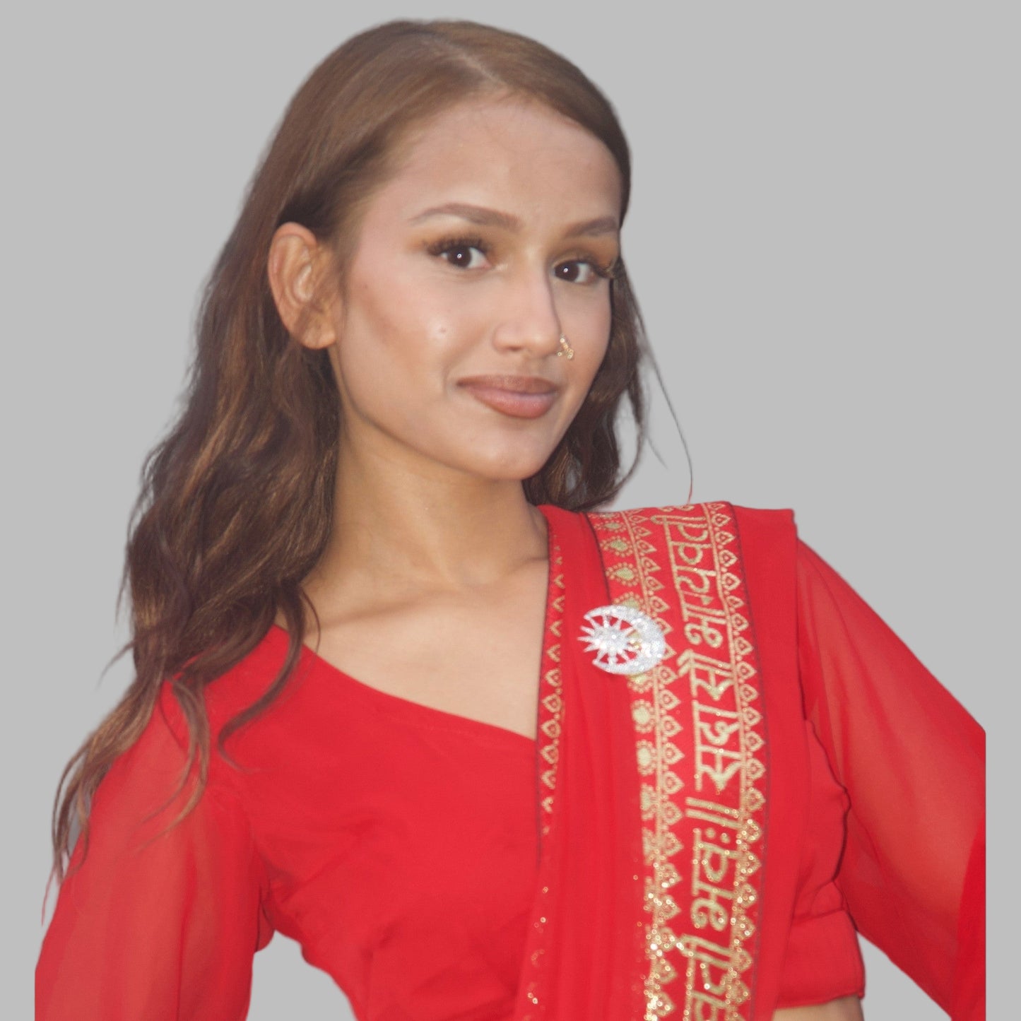 Woman wearing a red traditional outfit with Saree Pin.