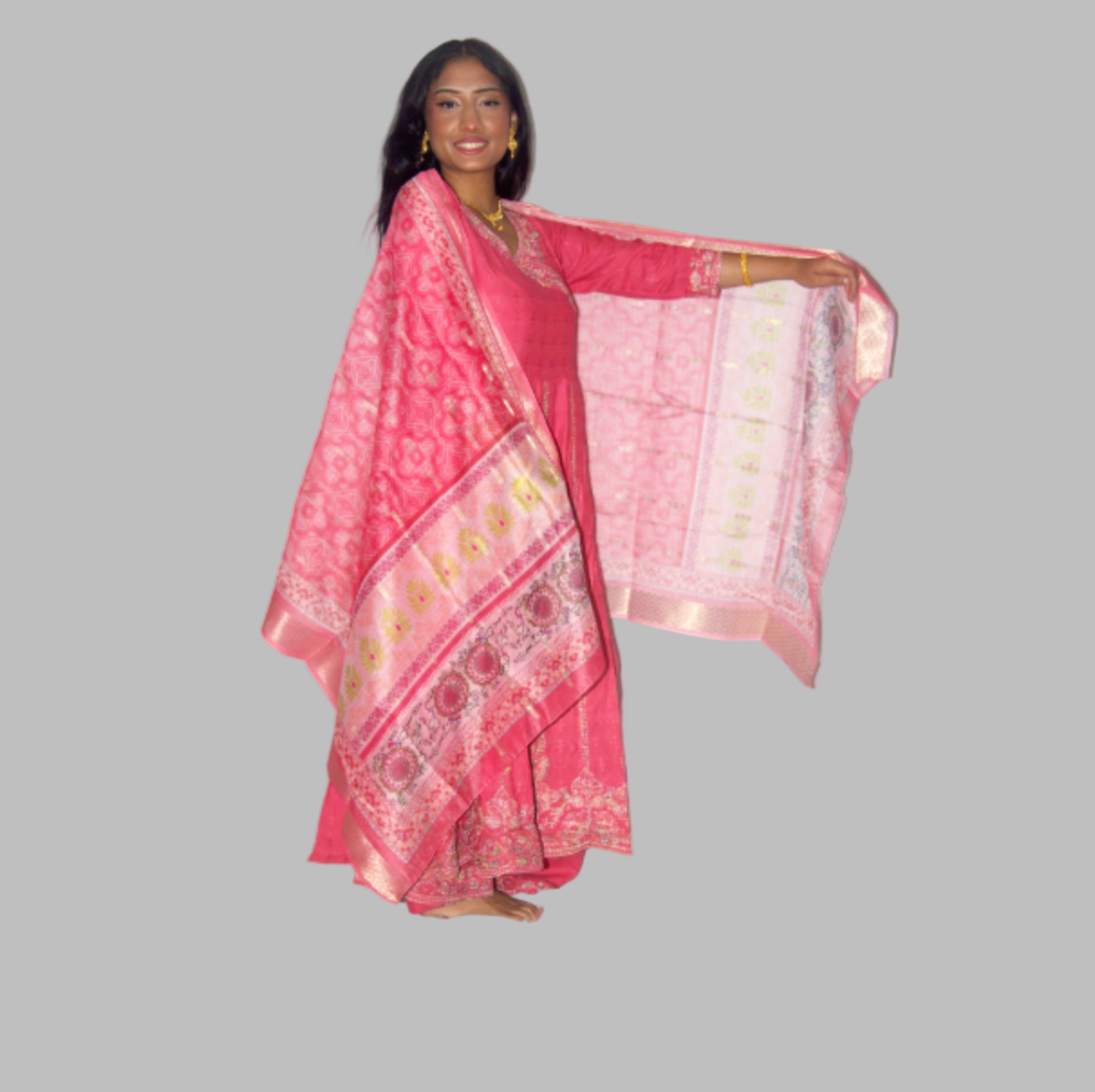 Woman wearing a pink traditional outfit with a white background