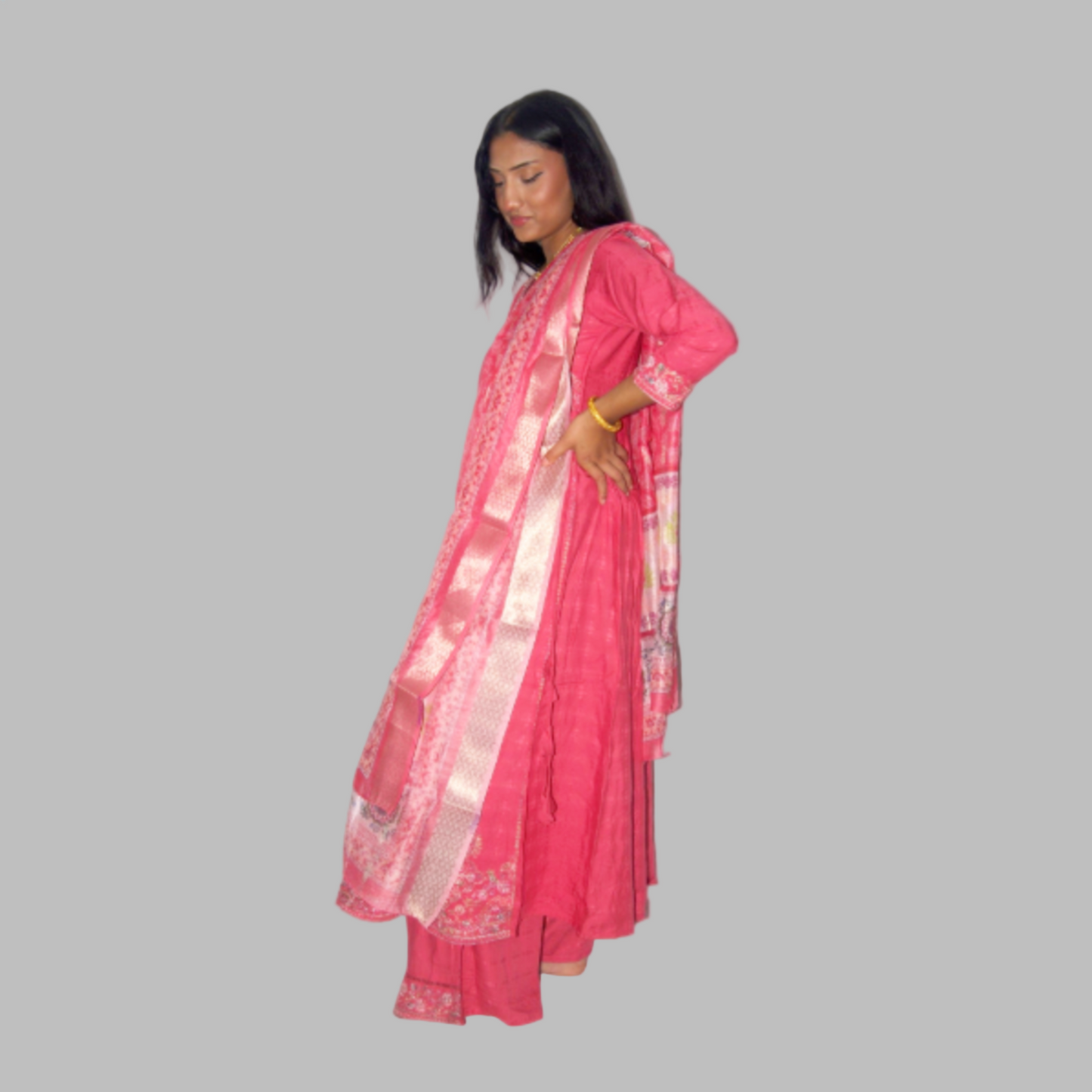 Woman wearing a pink saree with a white border on a white background