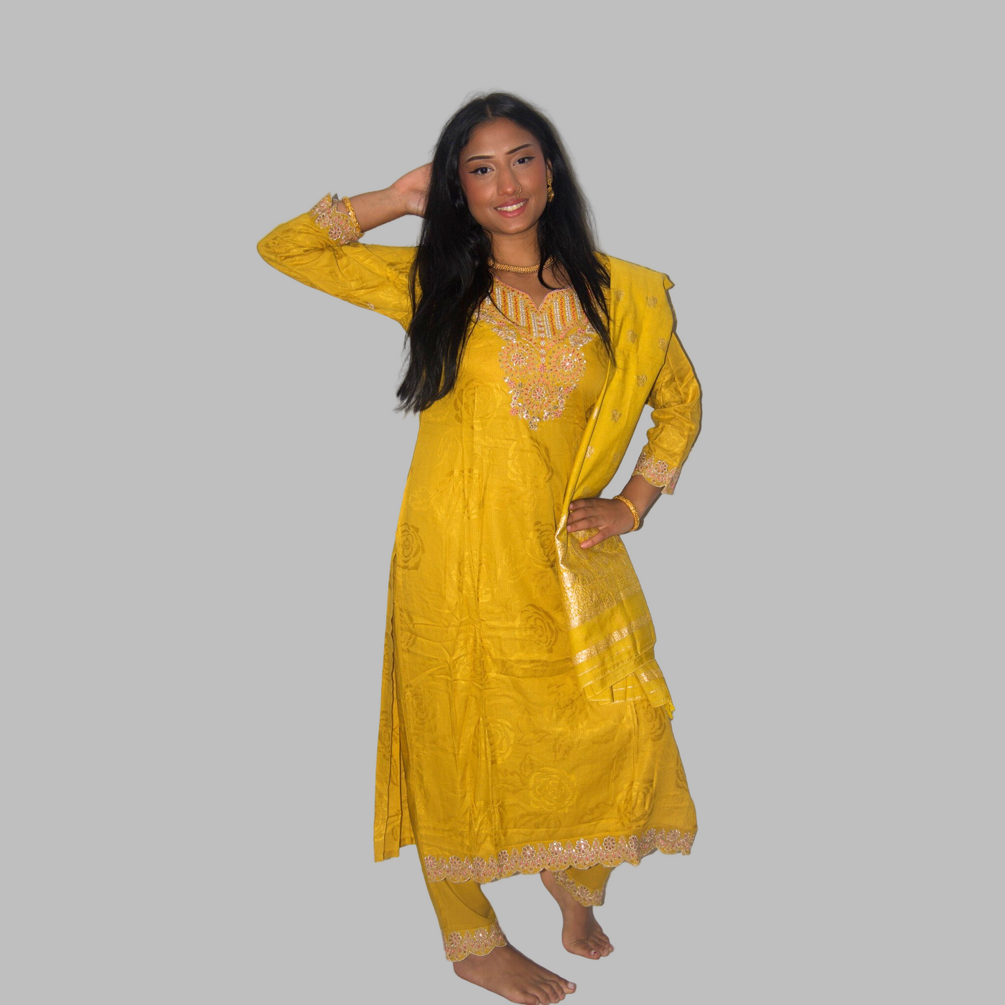 Woman wearing a yellow traditional outfit with a white background