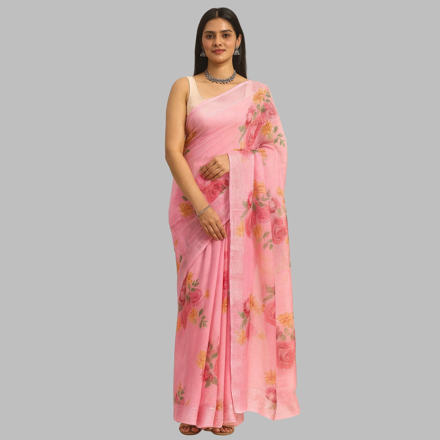 Woman wearing a pink saree with floral patterns on a beige background