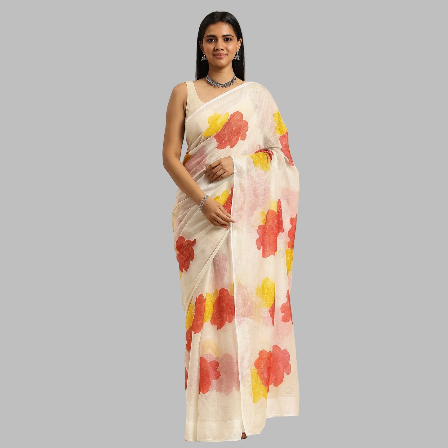 Woman wearing a white saree with red and yellow floral patterns on a beige background