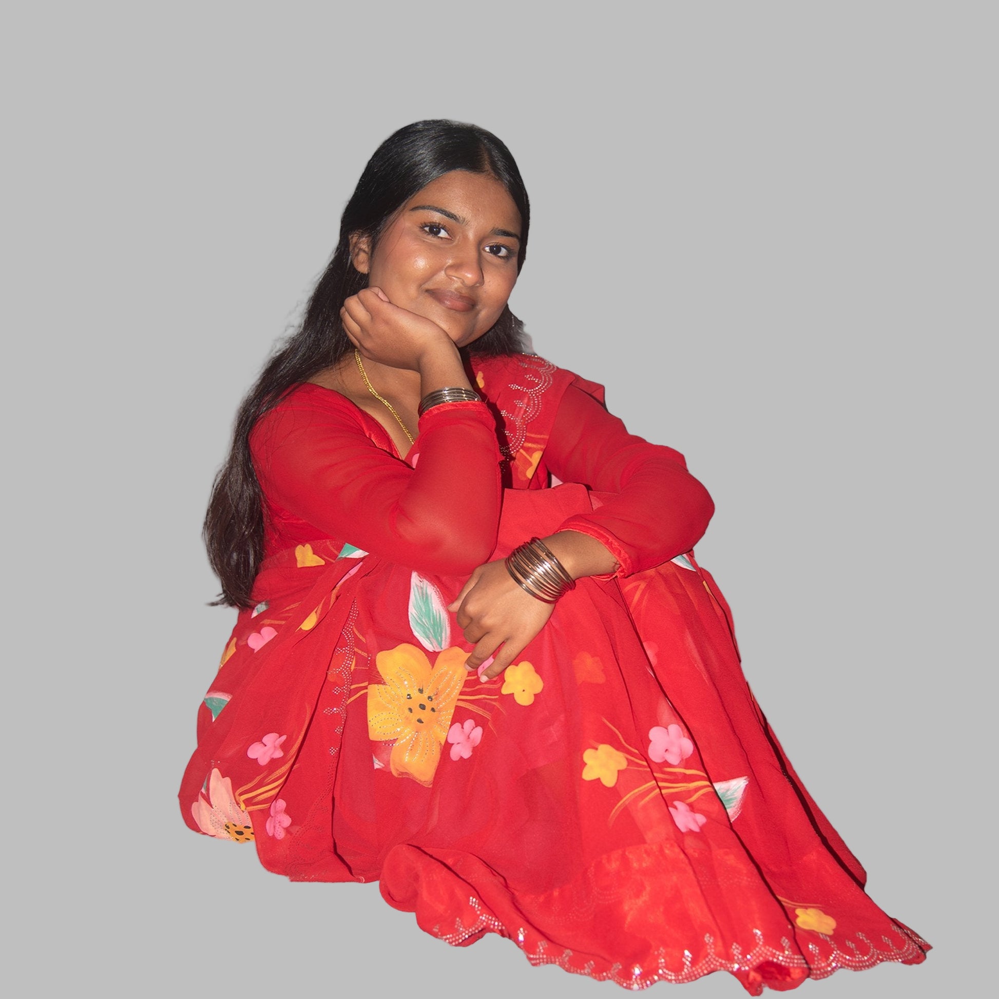 Woman wearing a red floral dress on a gray background