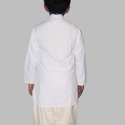 Person wearing a white checkered kurta with a plain background