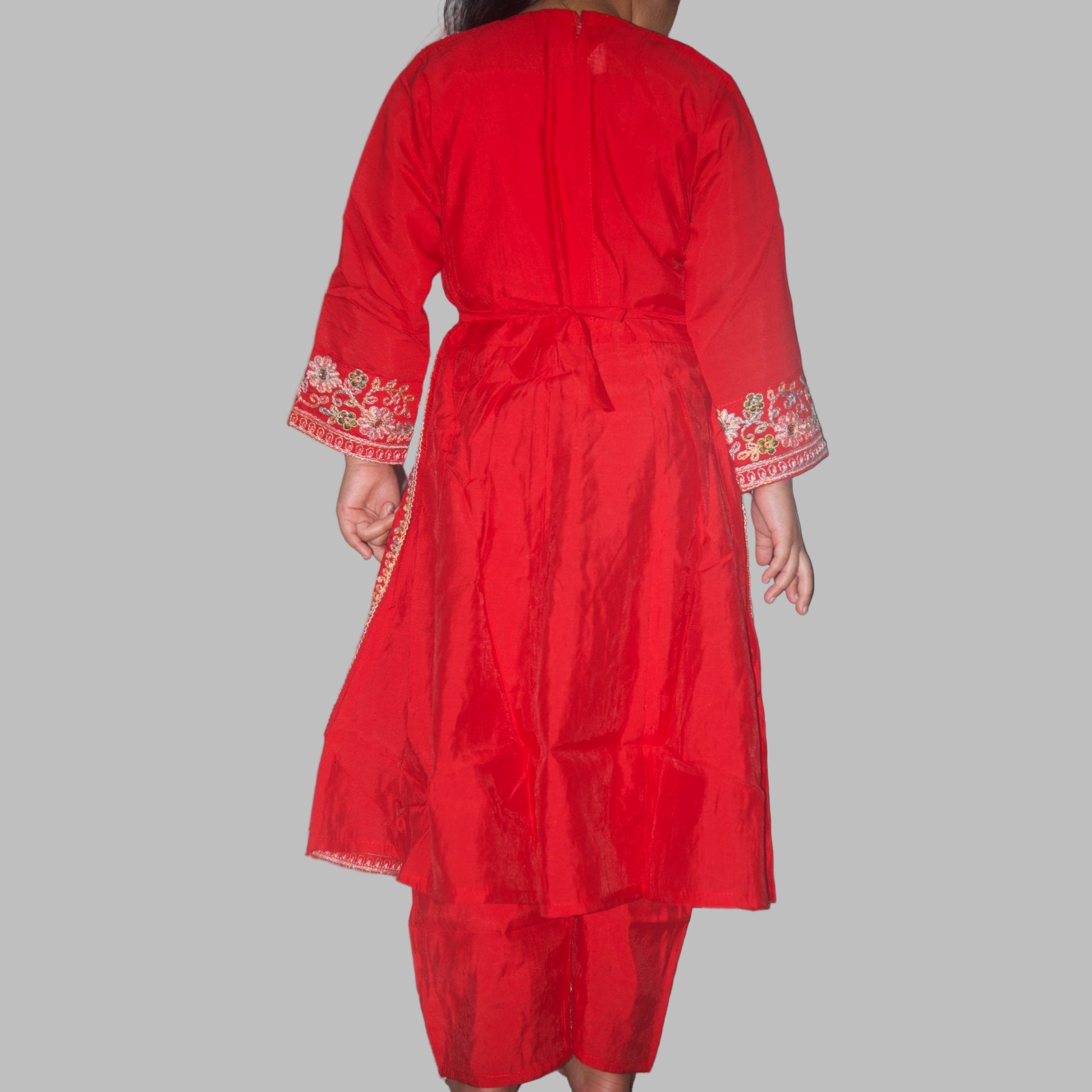 Red dress with floral embroidery on a plain background