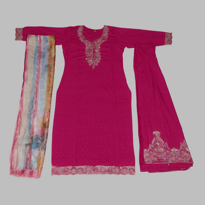 Pink traditional outfit with embroidered details on a white background