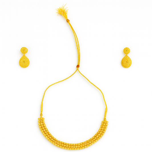 Yellow beaded necklace and earrings set on a white background