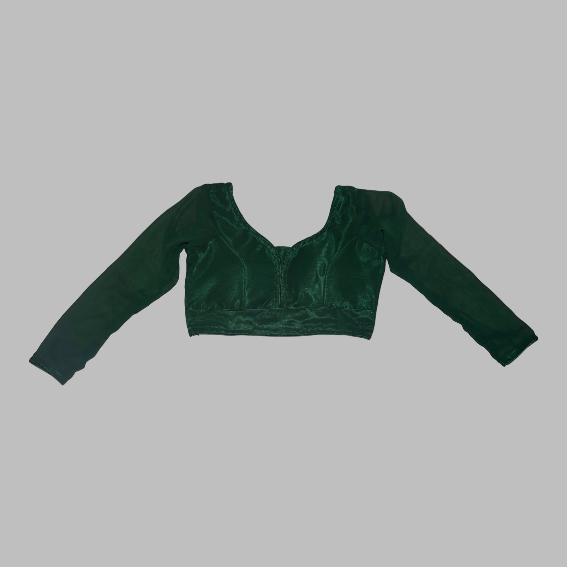Green velvet crop top with long sleeves on a white background