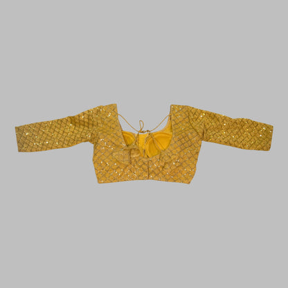 Gold patterned blouse on a white background