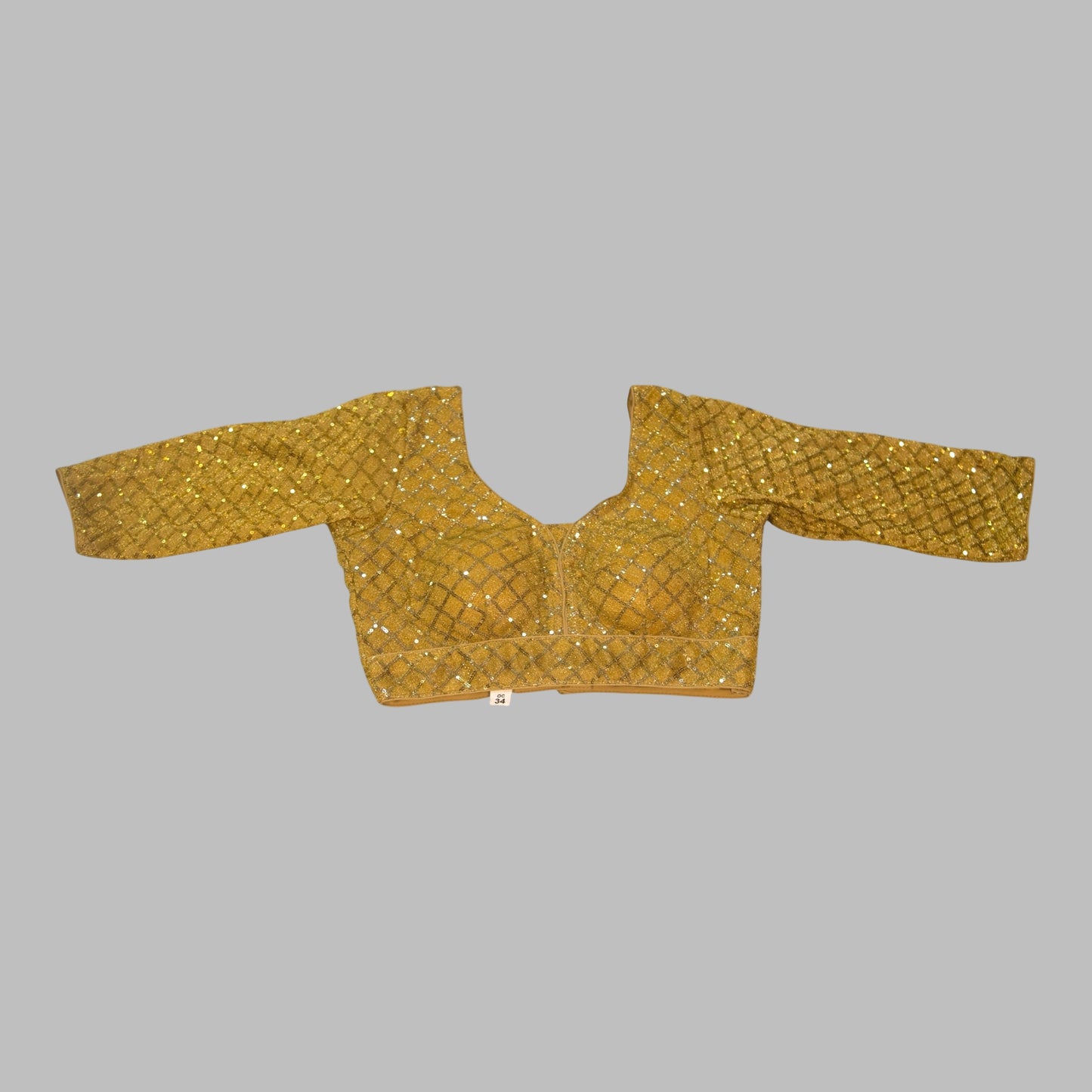 Gold embroidered blouse on a white background