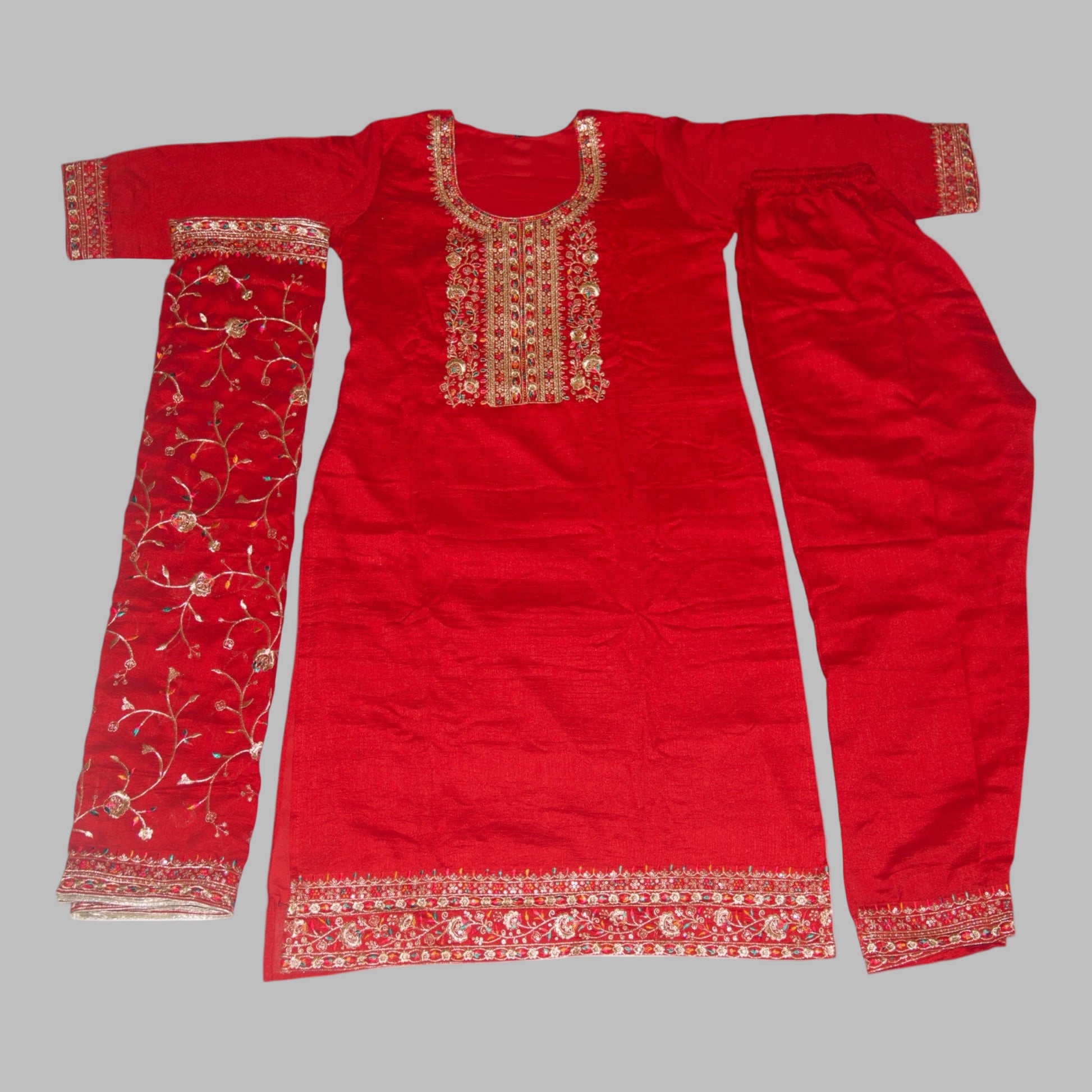 Red traditional outfit with intricate gold embroidery on a white background