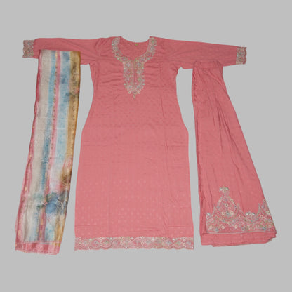 Pink traditional outfit with embroidered details on a white background
