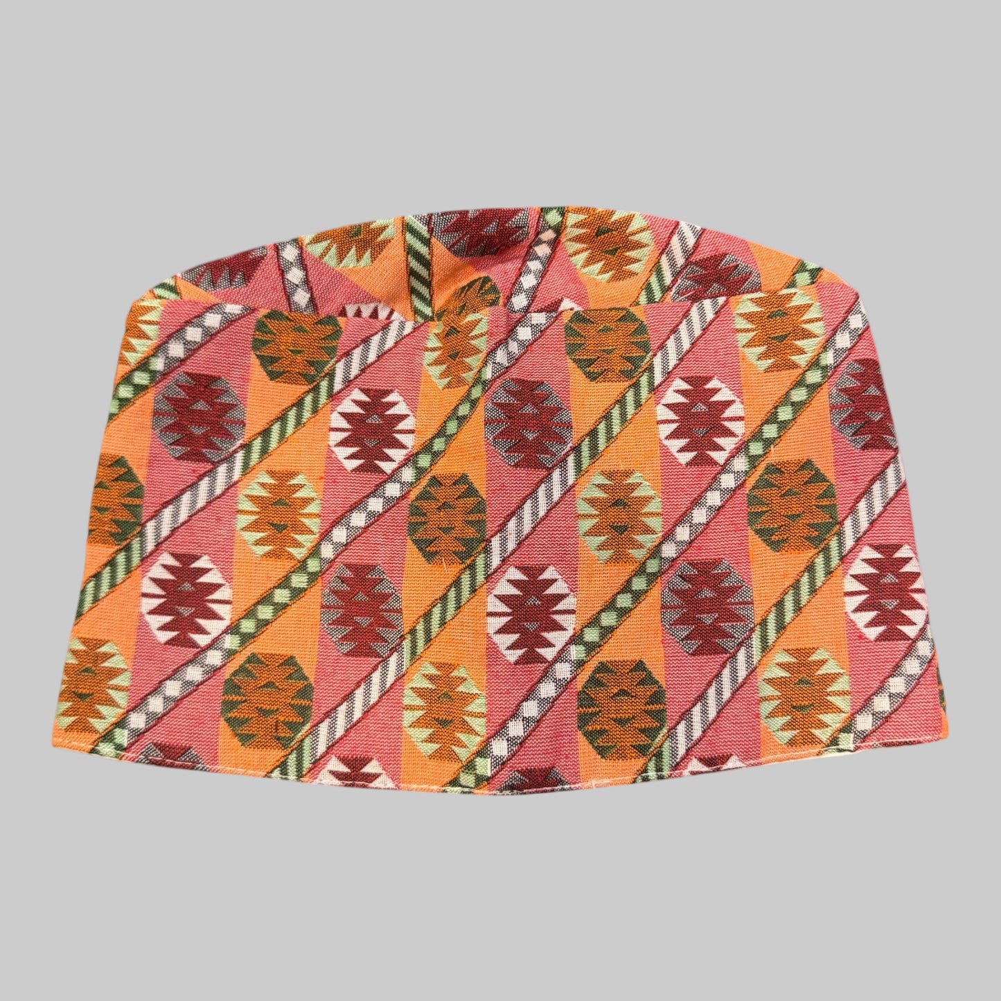 Colorful patterned Dhaka Topi on a white background