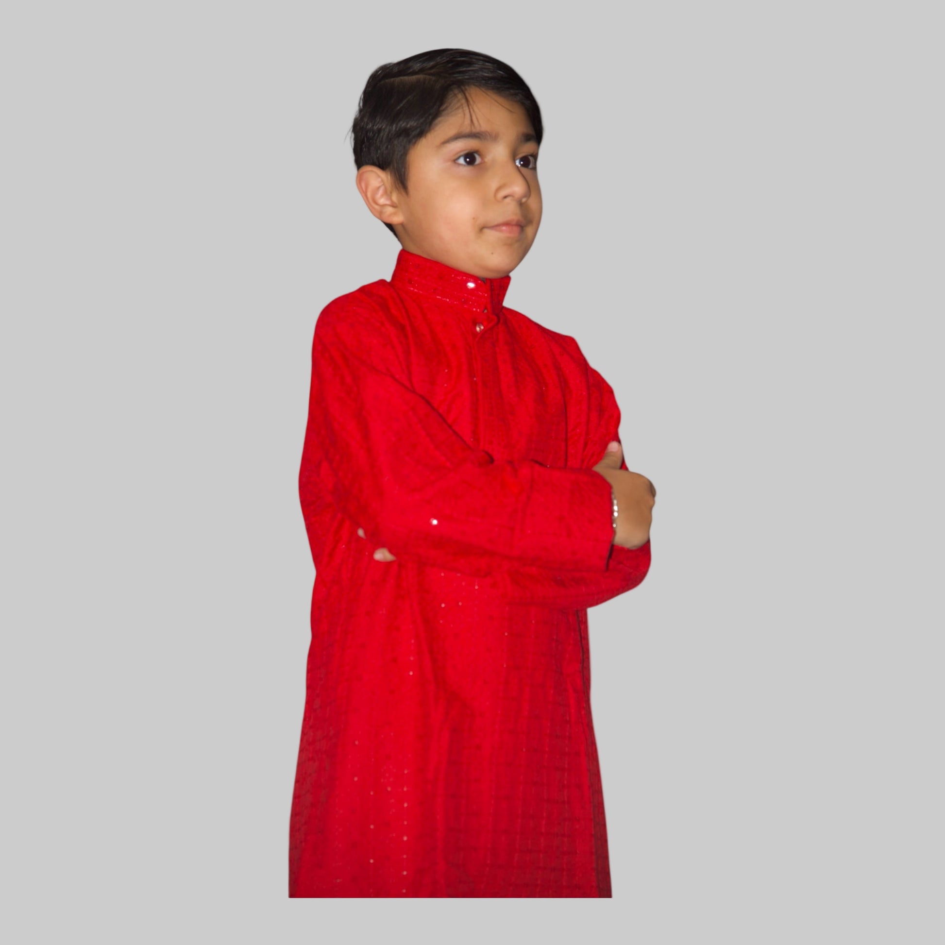 Child wearing a red traditional outfit on a white background