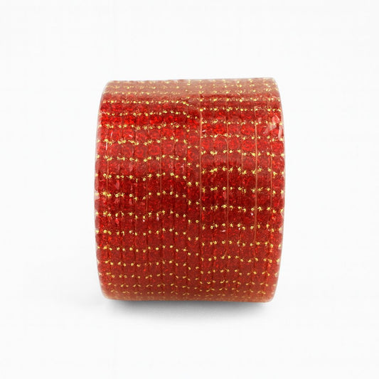 Red bangles with gold glitter on a white background