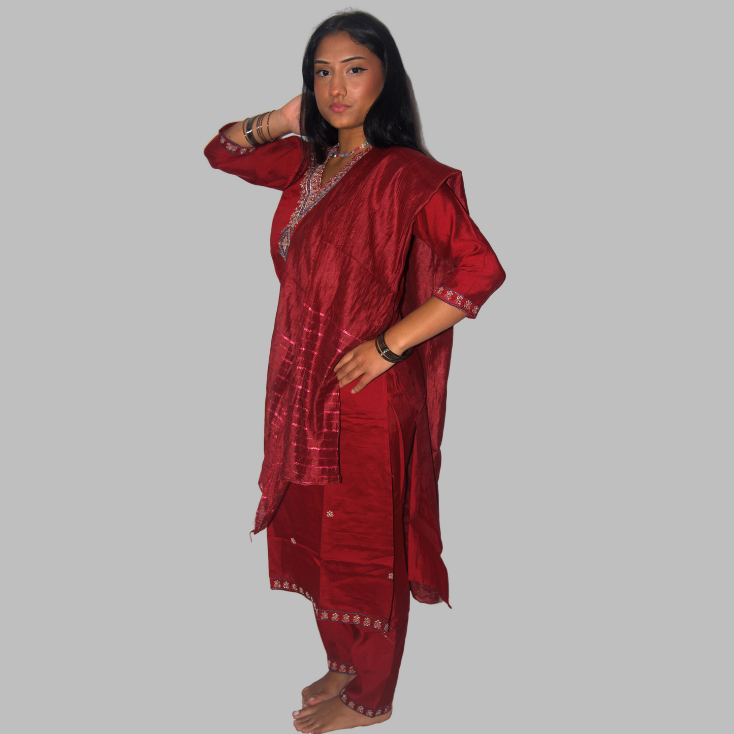 Woman wearing a red traditional outfit on a white background
