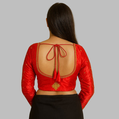 Red blouse with open back and black skirt on a beige background
