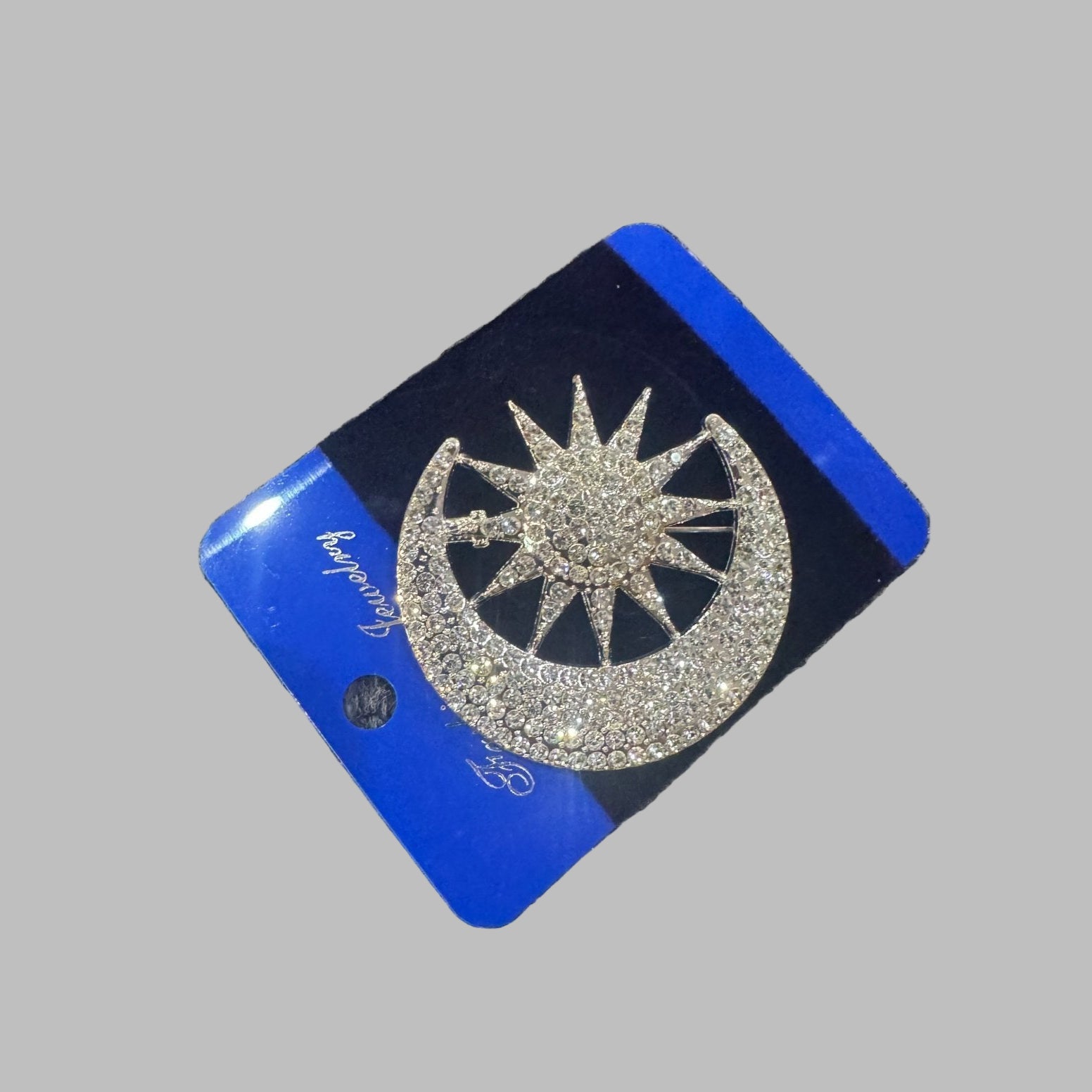 Blue card with a silver sun design on a textured surface